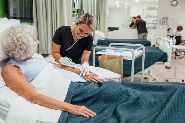 A nurse providing wound care treatment to a patient in a clinical setting in Dallas & Mansfield, TX