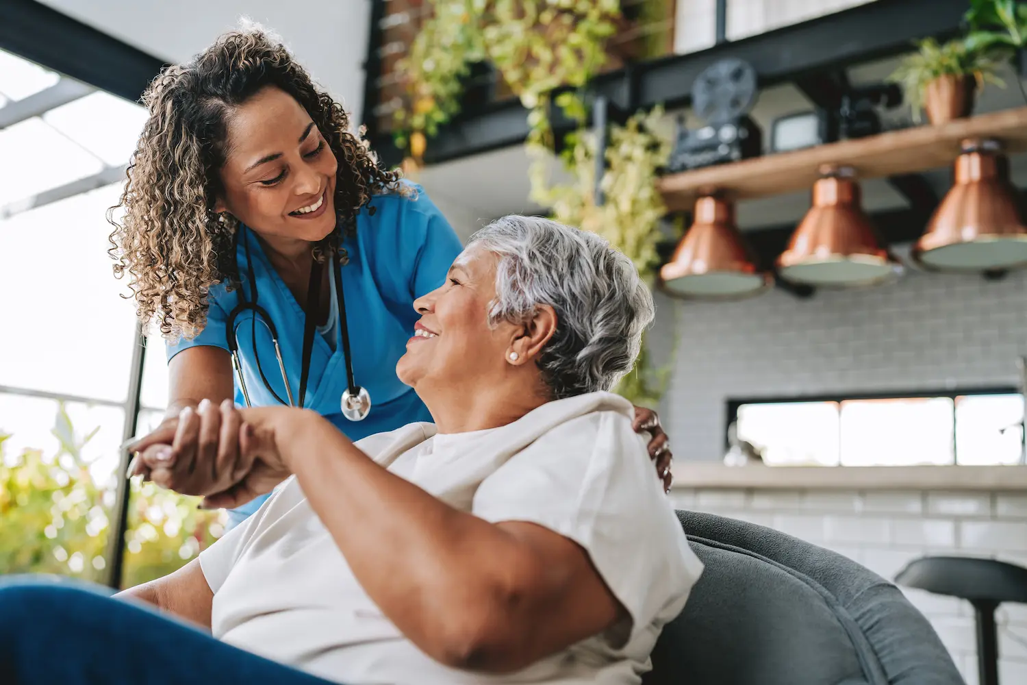Healthcare Professional Gently Holding a Senior's Hand During Treatment of a Wound in Dallas, TX